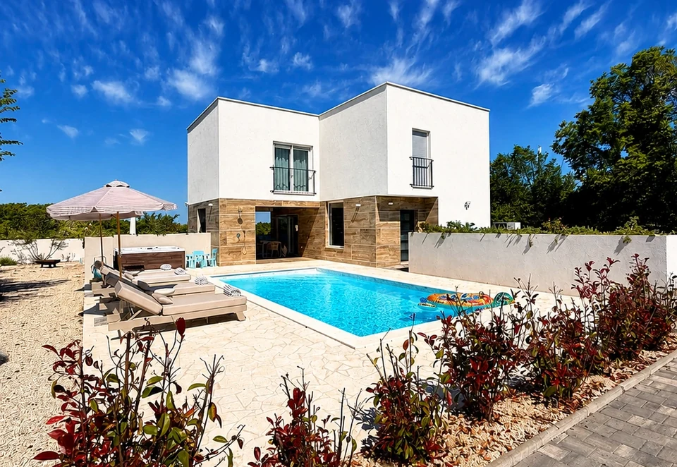 Villa Julija exterior with heated pool and sun loungers
