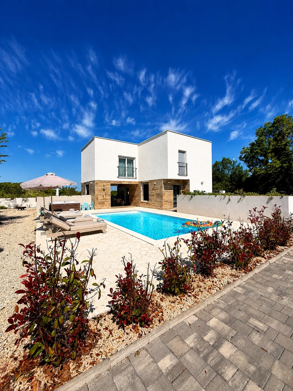 Villa Julija exterior with heated pool and sun loungers